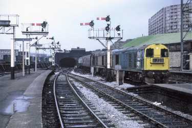 Diesel locomotive at Sheffield Midland railway station showing (top right) Park Hill Flats