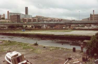 South Yorkshire Passenger Transport Executive (SYPTE). Canal basin prior to restoration showing (centre) Parkway Supertram bridge, (top left) Hyde Park flats and (top left) Park Hill Flats