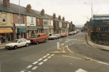 Holme Lane at the junction of Rivelin Valley Road showing (right) Burgon and Ball Ltd., tool manufacturers, La Plata Works and (left) No. 224 Harvest Fayre and No.226 Metro Village, video shop
