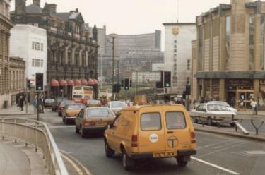High Street looking towards the junction with (left) Haymarket, (right) Fitzalan Square and (centre) Commercial Street showing (right) Cooplands Ltd., bakers, No. 1 Fitzalan Square
