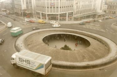 Castle Square (also known as the Hole in the Road) at the junction with (top left) Angel Street and (top right) High Street showing (top centre) Waring and Gillow, Nos. 51 - 57 and C and A Modes Ltd., Nos. 59 - 65 High Street