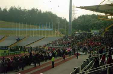 Spectators at the start of the Olympics 2012 torch procession at Don Valley Stadium