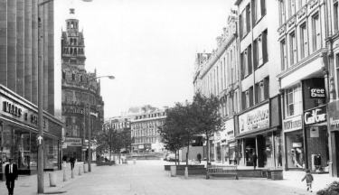 Shops on Fargate showing (left) Nos. 19 - 31 Marks and Spencer and (right) No. 16 Cecil Gee, gents outfitters and tailors, No. 18 Ricky Outsizes Ltd., costumers and Nos. 20 - 26 Proctors Ltd., house furnishers