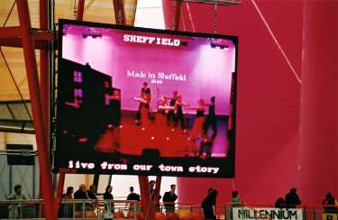 Inside the Millennium Dome with the screen showing 'Made in Sheffield - Live from Our Town Story' for the event celebrating 'Our Town Story'