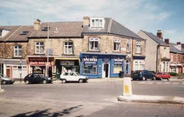 Shops on Common Side showing (l. to r.) No. 15 Janettes, barbers; No. 17 Flower Bok and No. 19 WRD Building Services and (right) Sydney Road