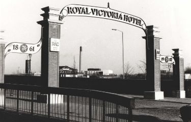Entrance archway to the Royal Victoria Hotel, Victoria Station Road showing (centre) the Bernard Road incinerator
