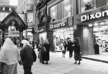 Fargate showing (left) the entrance to the Orchard Square [Shopping Centre] showing No. 58 Dixons Ltd., photographical equipment, audiovisual and electronics store 