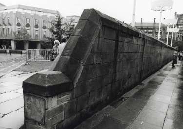 Wall to rear of bus stops on Pinstone Street showing (left) Peace Gardens and Town Hall Extension (also known as the Egg Box (Eggbox))