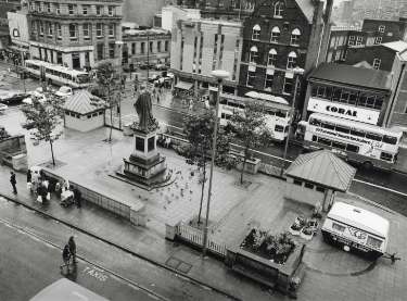 Fitzalan Square showing (top l. to r.) No. 1 Cooplands Ltd., bakers; No. 5 Fitzalan Square Discount Centre (former premises of the Bell Hotel), No. 9 Coral, bookmakers and (centre) the King Edward VII Memorial Statue