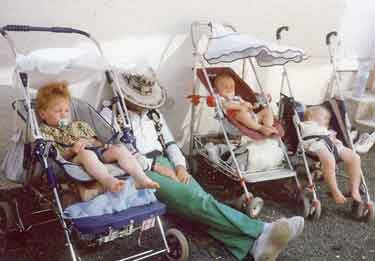 Sheffield City Morris member asleep amongst the children's buggies, Montoire, France