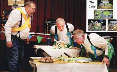 Sheffield City Morris members celebrating 50 years of the group with cake made by fellow member Jules Goodband