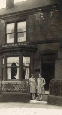 Unidentified women outside house