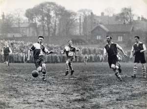 Sheffield Rovers FC., T. Sergeant breaks through closely followed by G. Watson and watched by 3 Hallam FC defenders during the Amateur League semi final at the Waterworks ground, Crookes (Hadfields sports ground), [c. 1950]