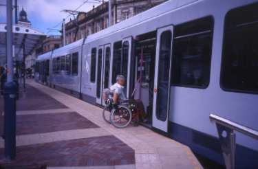 Wheelchair user boarding Supertram at Castle Square Supertram stop 