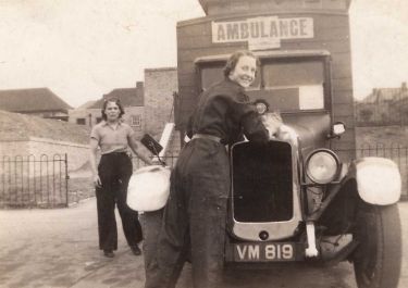 ARP ambulance with two female crew members at Hartley Brook School Depot, Sheffield, c. 1939