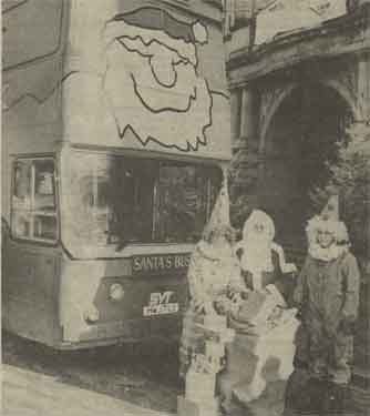 Santa and his bus outside Sheffield Town Hall