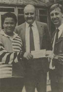 Former pupil of Herries School, David Barnet (right), receiving a cheque for over 200 pounds towards his research into Leukemia at the Northern General Hospital