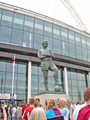 Sheffield United and Burnley fans mingle around the statue of Bobby Moore outside Wembley Stadium before the Championship play-off final 