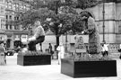Display for Entente Florale showing Sheffy Stan the Steelman (left) and; Mary the Buffer Girl (right) outside the Town Hall
