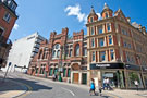 Looking towards the former Salvation Army Citadel, and John Lewis, department store on Cross Burgess Street from Pinstone Street