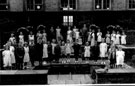 1949 May Queen Crowning Ceremony group photograph taken by the pond in the quadrangle at  Hartley Brook Primary School, Champion Road