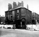 Partly demolished row of buildings known as Pool Place, Barker's Pool (later the site of the City Hall). Former premises include New Music Hall Tavern, No 116, Barker's Pool, on corner