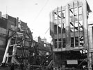 View: s01151 High Street, Burton Montague Ltd., tailors and Nos. 59 - 65 C and A Modes Ltd., showing air raid damage, World War II