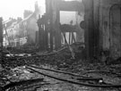 Site of E. Weston and Co., newsagents, Change Alley, showing air raid damage