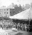 View: s01572 Queen Victoria's visit, Town Hall Square, military band. No. 70 Charles A. George, chemist, in background