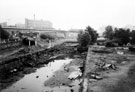 Derelict Sheffield Canal with Hyde Park Flats and Supertram Viaduct in the background