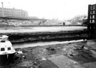 View: s01709 Sheffield Canal Basin, drained for renovation work with Hyde Park Flats and Supertram Viaduct in the background