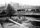 Sheffield Canal Basin area drained for renovation work with Hyde Park Flats and Supertram Viaduct in the background