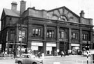 View: s01842 Norfolk Market Hall, Haymarket, prior to demolition. Premises include No. 28 G.E. Inman, pastry cook, No. 30 H.P. Tyler, boot makers, No. 38 Tyler and Co., tobacconists
