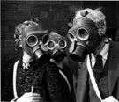 Trying on gas masks during World War Two