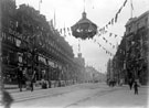View: s03291 High Street at Market Place, decorated for royal visit of King Edward VII and Queen Alexandra, Nos. 66-70 Bodega Co. Ltd., wine and spirit merchants and Nos. 44-64 J. Walsh Ltd., general dealers, in background