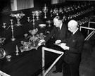 Col. E.W. Wilkinson and A.J. Harris arranging exhibits for the 'Sheffield On Its Mettle' Exhibition