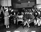 Members of the Women's Legion in Sheffield, receiving instruction on the working of a car engine, in their club room