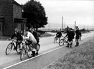 Cyclists at Owler Bar. Old toll cottage in background