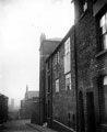 School Lane, looking north towards junction with School Street and St. John's School (Infants), St. John's School and slum housing including entrances to Court 7 and 16, in foreground