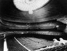 Oval Hall from platform, City Hall. The Oval Hall contains seating for 2,885 people. Used for concerts, meetings and religious services. City Hall Lions on right