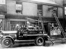 Fire engine outside fire damaged household furnishers shop Nos. 60 - 62 Langsett Road. R. A and E. S. Smith, cycle dealers, No. 64 Langsett Road, left. Wellington Inn just out of picture on the right
