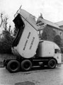1951 type refuse collector. Tllting to pack the load