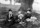 Family group related to Mr. Johnson (his mother and grandmother sitting under the tree)