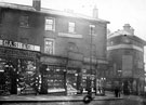 Angel Street at junction with Bank Street towards Snig Hill, No. 21 Cash and Co., boot makers, No. 23 Joseph Greenwood, hatter, No. 25 Fred Dover, confectioner, No 27, Herbert Bingham, umbrella manufacturer, No. 29 F.C. Webb, hosier and glover