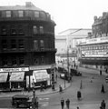 View: s13292 Town Hall Square and Barkers Pool, Town Hall Chambers, William Timpson Ltd., shoe shop and J. Lyons and Co. Ltd., dining and tea rooms on left, Cinema House on right