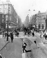 View: s15350 Re-laying the tram tracks on Pinstone Street at Moorhead, Nelson Hotel, right (with flag), Roberts Brothers Ltd., left, St. Paul's in distance