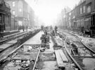 Tram track laying on South Street, Moor, including Nos. 170 - 174 Paul Silvester Wainwright, outfitters, No. 180 Ye Woodman public house, on left