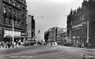 View: s15576 Fargate, 1940-1955, Bank Chambers including Nos. 62 and 64, Anne Lennard Ltd., costumiers, left, shops on right include No 61, Scholl's (Dr.) Ltd., No. 63, Bradwell Bros., umbrella manufacturers and Carmel House