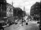 View: s15600 Elevated view of Fargate from High Street, including No. 8 High Street, Kingdon and Son Ltd., tobacconist, Nos. 4 - 6 Boots Chemist, left, Cole Brothers, department store and 'Cole's corner', right