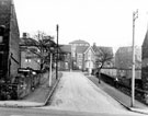 Nos. 36, 34, 32 and 30 Firth Park Crescent from Firth Park Road with housing on Windmill Lane in the background